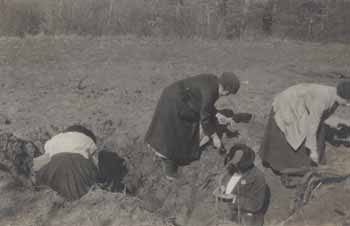 Women searching a bomb crater for souvenirs in France Photograph