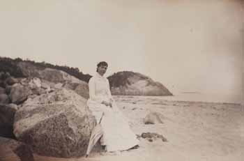 Mrs. Jim Scott seated on rock at east end of Singing Beach, Manchester Photograph