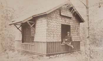 James Lowndes and dog in window of playhouse Photograph