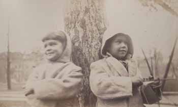 Helen and Del Hay in front of tree, Del with bow and arrow Photograph