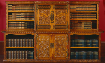 Carved oak bookcase Carved oak with decorative bronze hinges and lock,